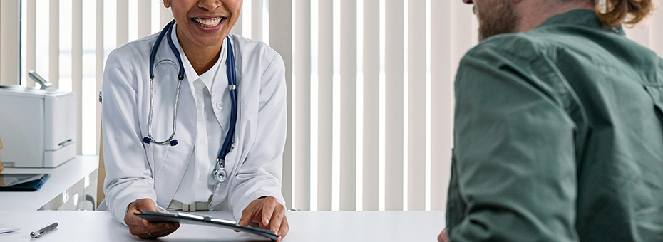 A health care provider looks at paperwork with another person